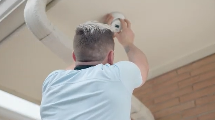 Technician installing security camera